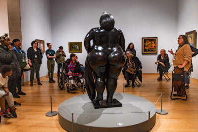 Guide Allison Sillers explains the significance of Fernando Botero’s Venus to patrons of the Women's Lunch Place during a tour at the MFA, Boston. (Jesse Costa/WBUR)