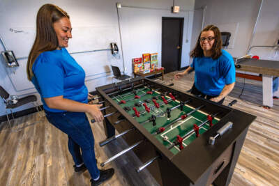 Makayla Lowe and Tonia O’Brien play at the foosball table in the PEACE recreational room at MCI-Framingham. (Jesse Costa/WBUR)