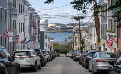 Flags and cables hang over Belmont Street, looking from Charlestown across the Mystic River to Everett. (Robin Lubbock/WBUR)