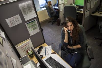 In this WBUR file photo, a volunteer speaks with a caller on the Samaritans hotline. (Jesse Costa/WBUR)