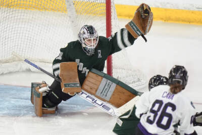 Boston goalie Aerin Frankel, left, grabs the puck for a save in front of Minnesota forward Michela Cava, right, during the third period of Game 1 of a PWHL hockey championship series, Sunday, May 19, 2024, in Lowell. (Steven Senne/AP)