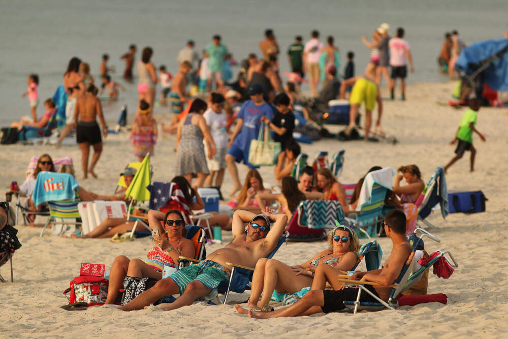 Visitors enjoy Mayflower Beach in Dennis at high tide in 2019. (Boston Globe via Getty Images)