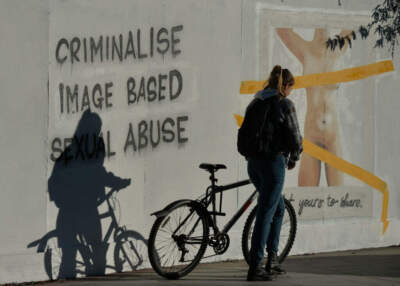 A woman walks by the latest mural by Irish artist Emmalene Blake, located in the center of Dublin, Irland on on Friday, November 27, 2020.
The artist's latest work is related to the legislation outlawing so-called 'revenge porn', which is sexual abuse based on images, and which is still not a crime in Ireland (Artur Widak/NurPhoto via Getty Images)