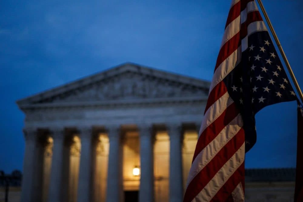 An abortion rights activist flies an upside down US flag, the international sign of distress, outside of the US Supreme Court during a protest in Washington, DC, on June 26, 2022, two days after the US Supreme Court scrapped half-century constitutional protections for the procedure. - Elected leaders across the US political divide rallied on June 26 for a long fight ahead on abortion -- state by state and in Congress -- with total bans in force or expected soon in half of the vast country. (Photo by Samuel Corum / AFP) (Photo by SAMUEL CORUM/AFP via Getty Images)