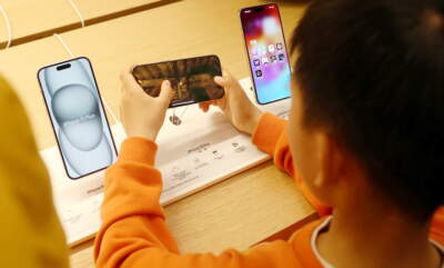 A child tries an e-sports game for the iPhone 15. (CFOTO/Future Publishing via Getty Images)