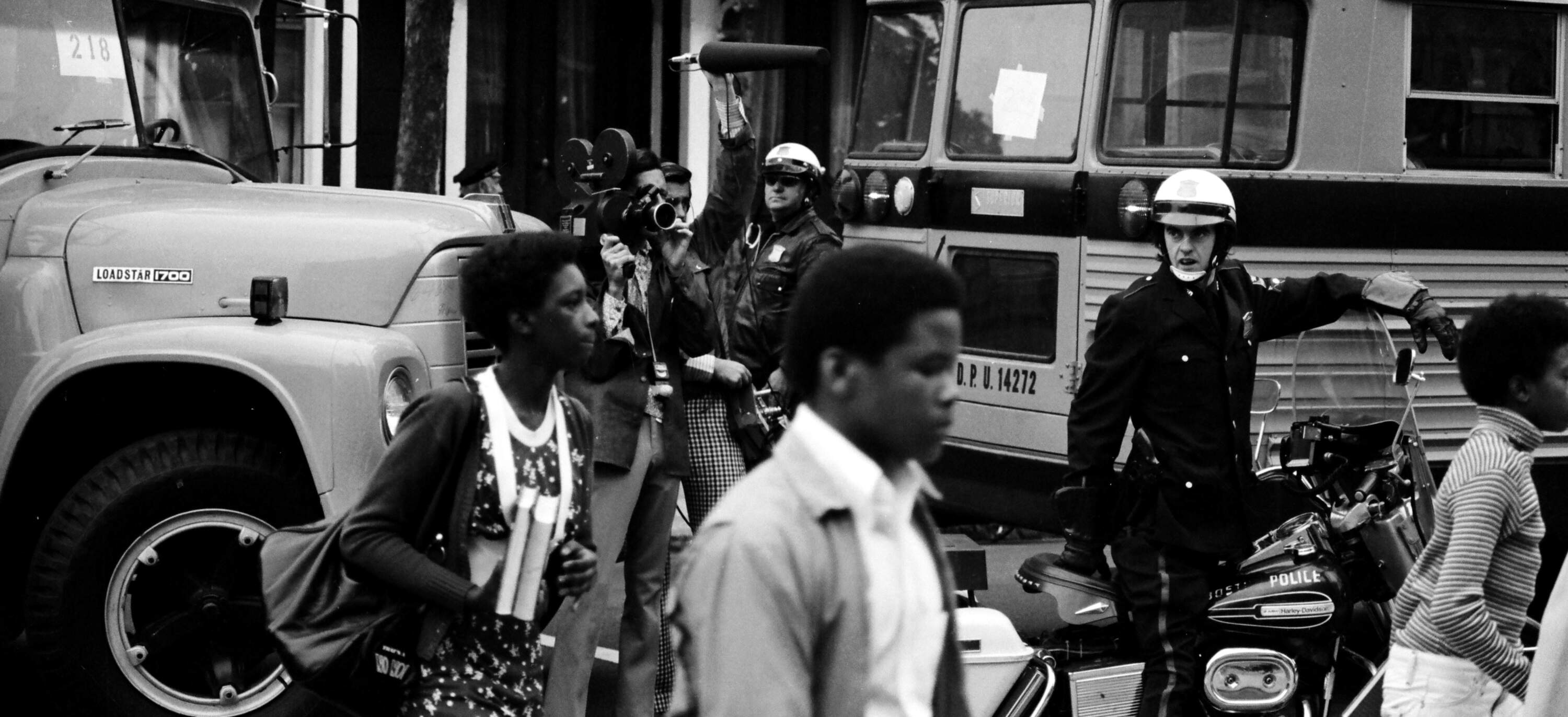 Bused Black schoolchildren arrive with police escort at South Boston High School during court-ordered desegregation in 1974. (Spencer Grant/Getty Images)