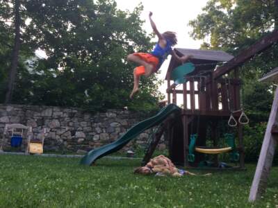 The author's son, as a child, flying off a swing. (Courtesy Erica Youngren)