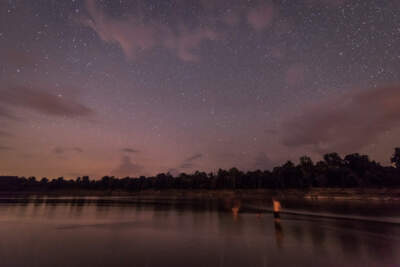 People swim in the Mississippi River at night. (Rory Doyle)