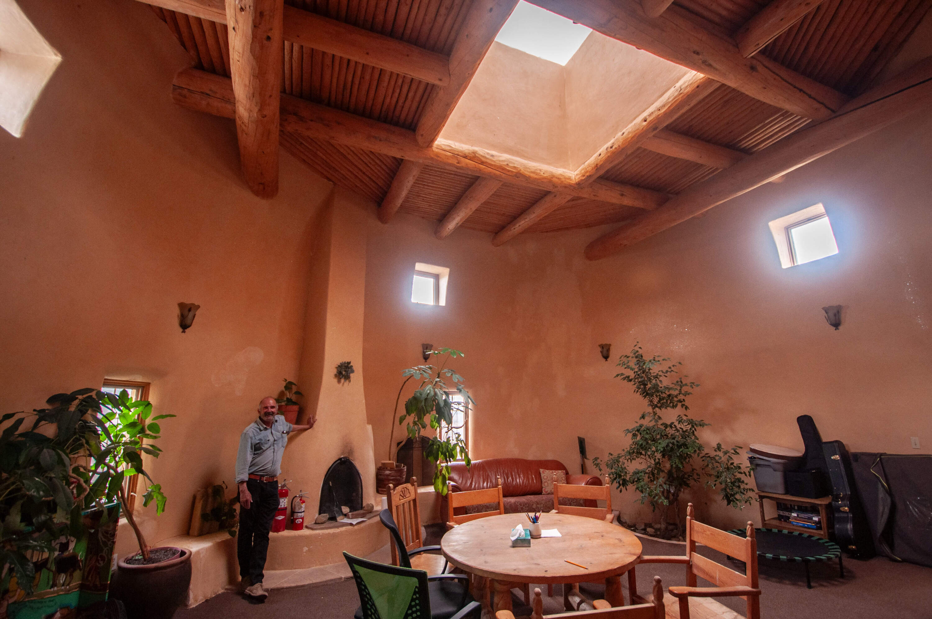 Architect Mark Goldman in the “round room” at the Dream Tree Project, a youth shelter he designed and helped build with adobe mud-bricks. (Chris Bentley/Here &amp; Now)