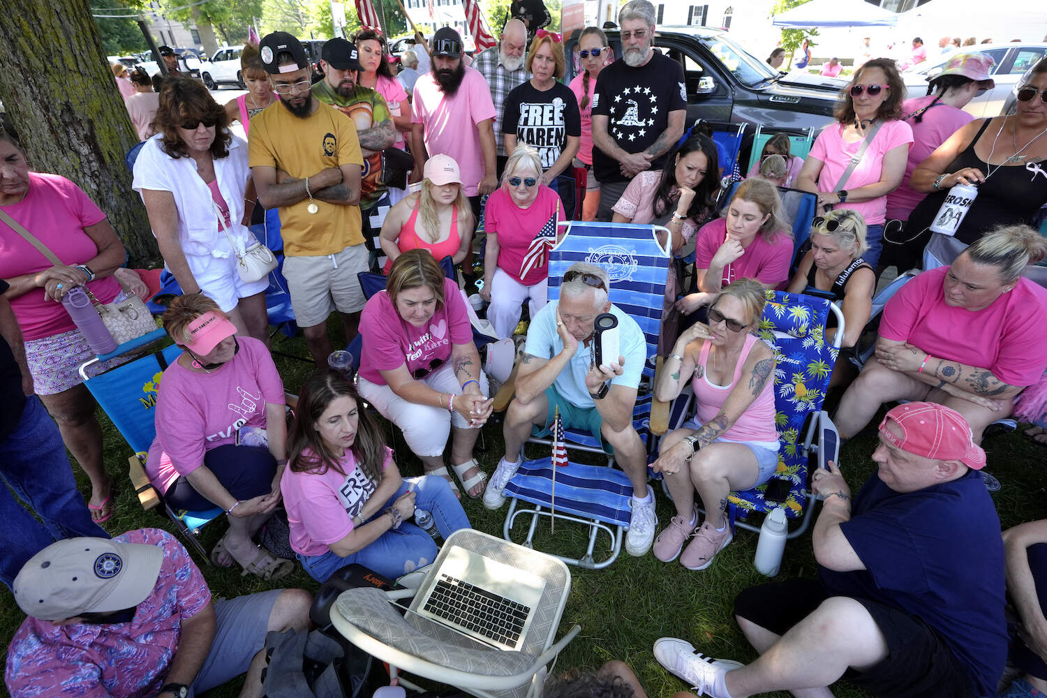 Supporters of Karen Read listen to proceedings from Read's trial from a laptop computer while gathered a block away from Norfolk Superior Court, Tuesday, June 25, 2024, in Dedham, Mass. (Steven Senne/AP)