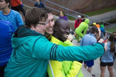 A group poses for a photo during a November Project workout at Harvard Stadium. (Jesse Costa/WBUR)