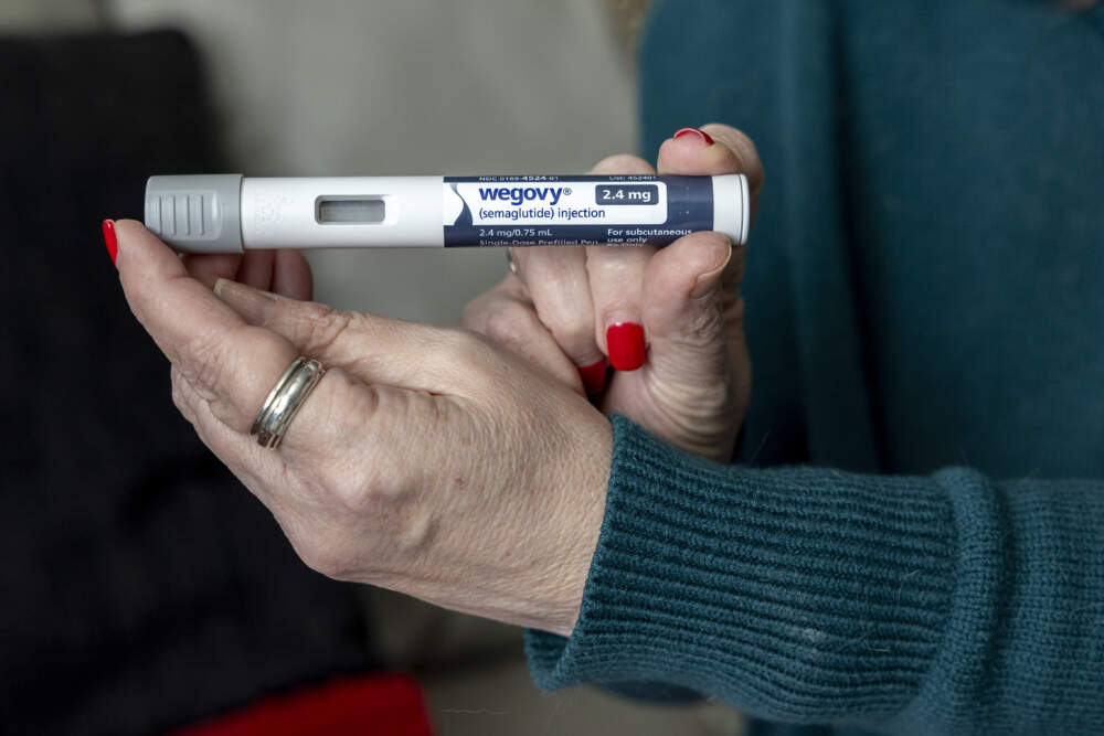 A patient holds up a dosage of Wegovy, a drug used for weight loss, at her home in Virginia. (Amanda Andrade-Rhoades/AP)