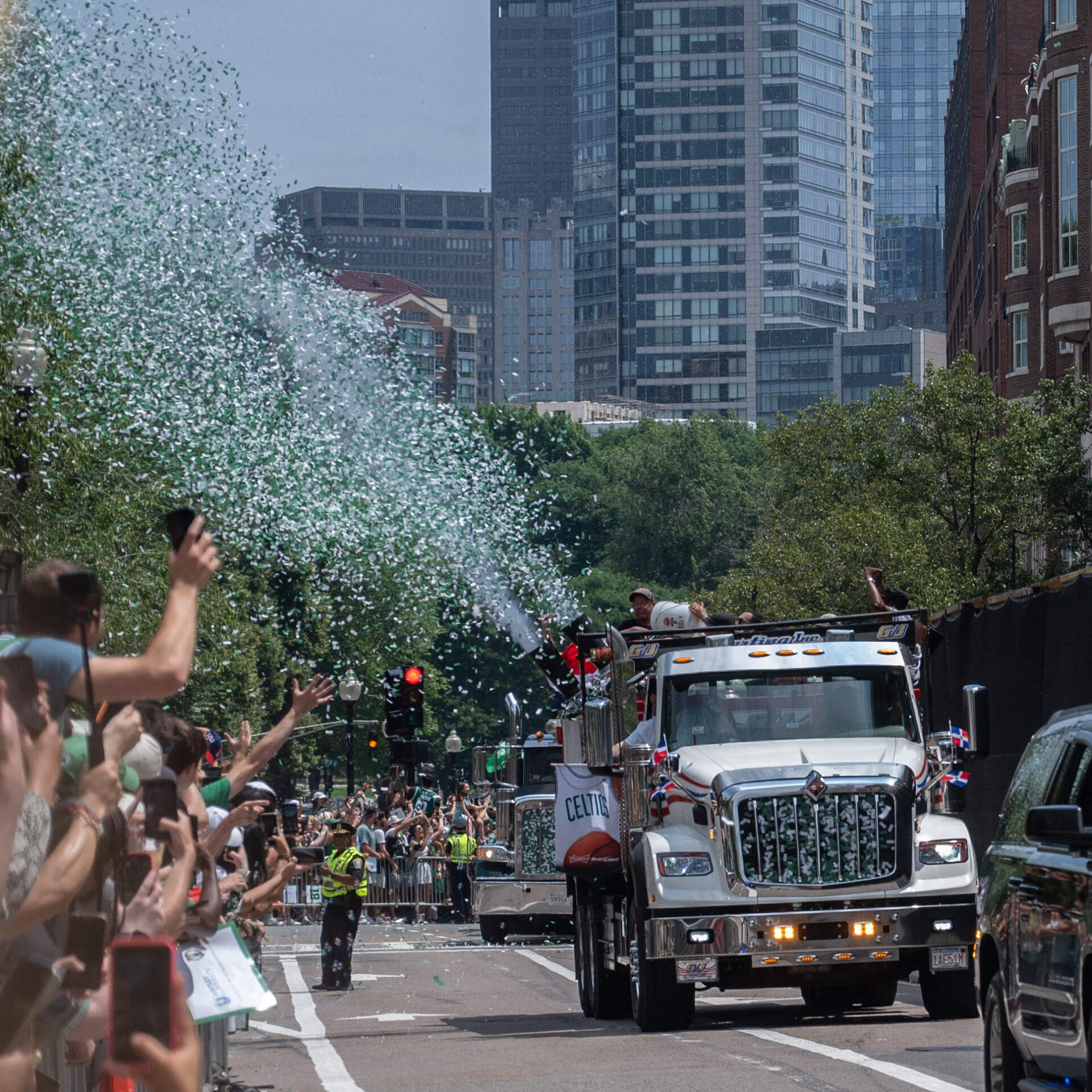 Confetti arrives on Boylston Street. (Sharon Brody/WBUR)